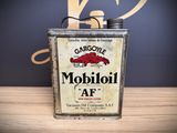 an old metal can with a sign on it sitting on a table