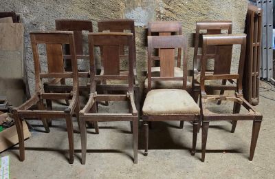 six chaises disposées dans une pièce, avec un mur en arrière-plan