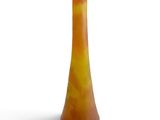 orange and yellow vase on a white surface with a white background