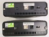 two black ethernets are sitting side by side on a white surface