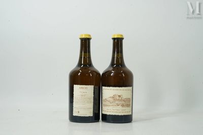 two bottles of wine sitting next to each other on a white surface