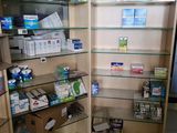 a shelf of medicine and other medical supplies in a room