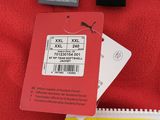 a close up of a red shirt with a yellow tag on it