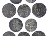 a close up of a bunch of coins on a white surface