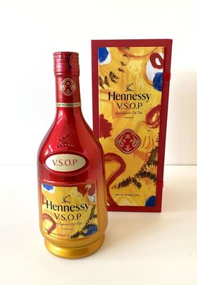 bottles of hennessy and a box of chocolates on a table