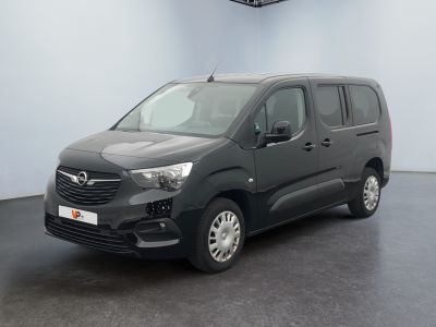 the grey van is parked in a large room with a black floor