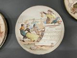 three plates on the wall that have pictures of people on them