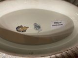 a white plate with a design on it on a table