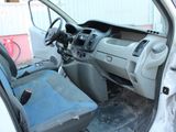 the interior of a white van with the door open and the driver ' s seat down