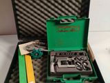 a green case with tools inside of it on a table