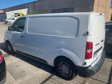 the white van is parked in the parking lot next to other cars
