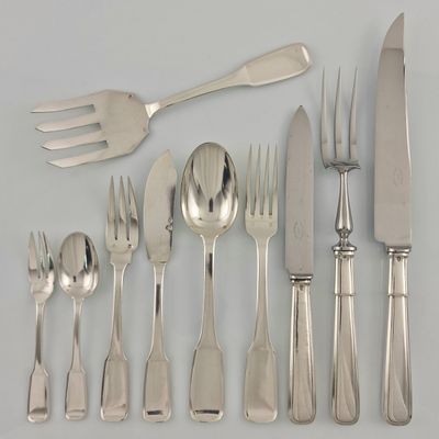a lot of silverware on a table with a knife, fork, spoon, and knife