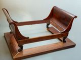 a wooden sleigh that is sitting on a stand