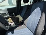 a car that has two seats in it and a bag in the back seat