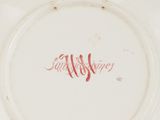 a white plate with a red writing on it