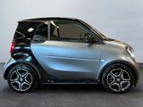 an image of a smart car parked in a showroom