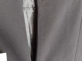 the back of a gray jacket with a zipper on it