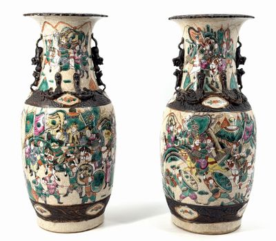 pair of chinese vases with floral designs on them against a white background
