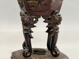 a brown vase that has a handle on it