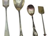 four spoons, a spatula, and a spatula on a white surface