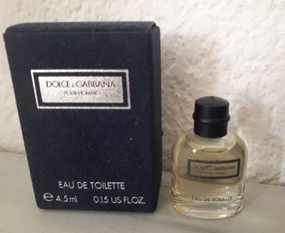 an image of a bottle of perfume next to a box