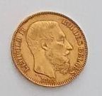 a close up of a gold coin on a white surface