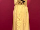 yellow trench coat on a mannequin stand against a red background