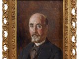 portrait d'un homme en costume-cravate dans un cadre doré