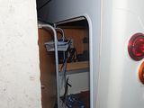 an image of a white bus parked in a garage