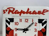 a white clock with a red and black design on it