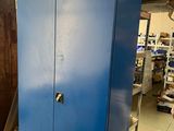 a blue cabinet in the middle of a room