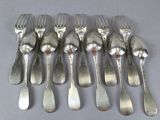 a lot of forks and spoons sitting on a table
