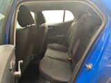 the back seats of a blue car with a black seat belt