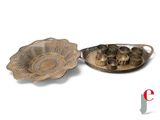 a silver plate with a bowl on it and a silver plate with a bowl on it