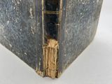 an old book opened to show the inside of it ' s cover