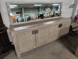 a large mirror on the side of a wooden cabinet