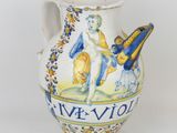 a white vase with a blue and yellow design on it