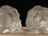 pair of clear glass shell bookends on a wooden table