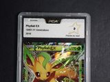 a close up of a pokemon card on a black surface