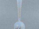 a glass vase with a bird design on it