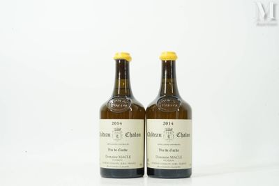 two bottles of wine sitting next to each other on a white surface