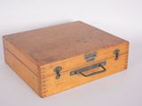 a small wooden box that has a handle on it