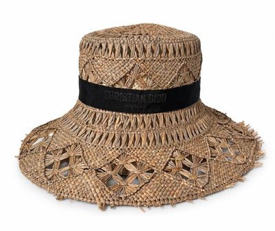 the hat is made of straw and has a black ribbon around the brim