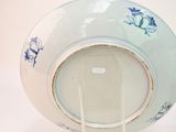 a blue and white plate with a blue flower design on it