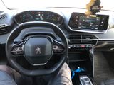 someone is sitting in the driver seat of a car with their feet on the steering wheel