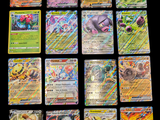 several pokemon cards are arranged on a black surface