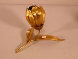 a gold flower that is sitting on a table