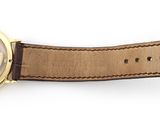 an image of a watch with a brown leather strap on a white surface