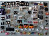 many different types of earrings on display on the table