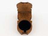 a small wooden box with a black lid on a white surface